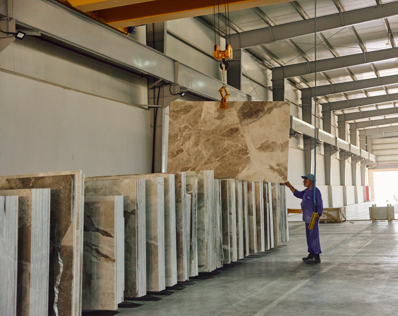 A veined marble slab raised in front of stone racks in an interior space