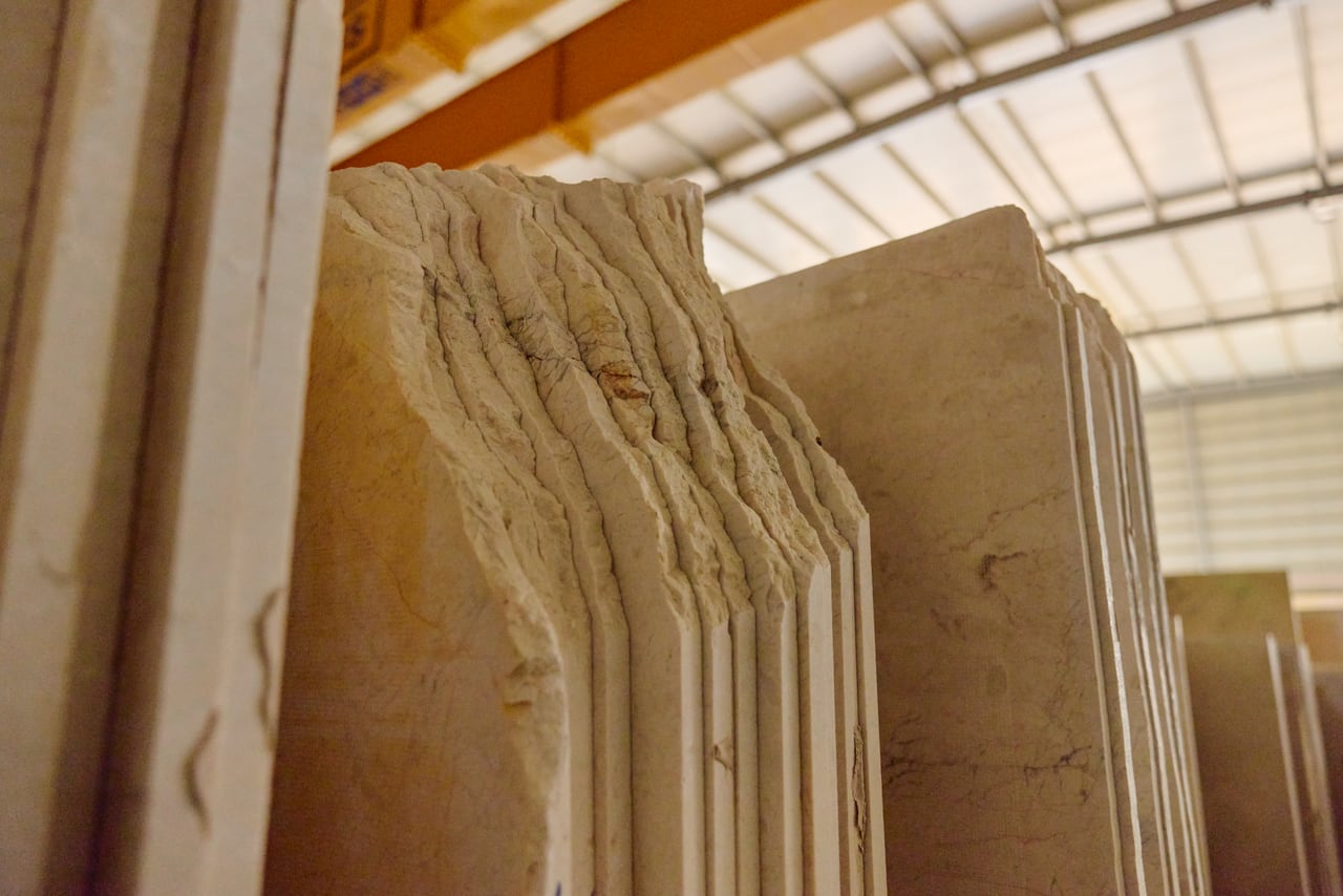 Stacked stone slabs showing their sawn edges