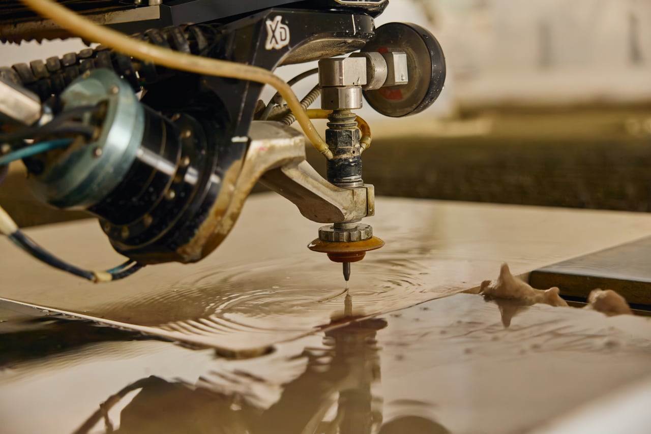 Machine head positioned above a stone surface